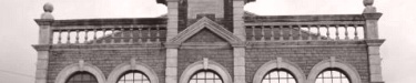 Photo banner of upper balustrades of library
                  facade