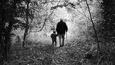 Grandfather and son walking down forrest path