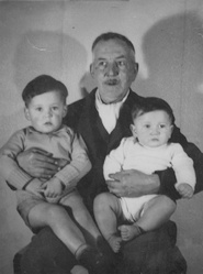 Jack holding
                his two grandsons (John on right)